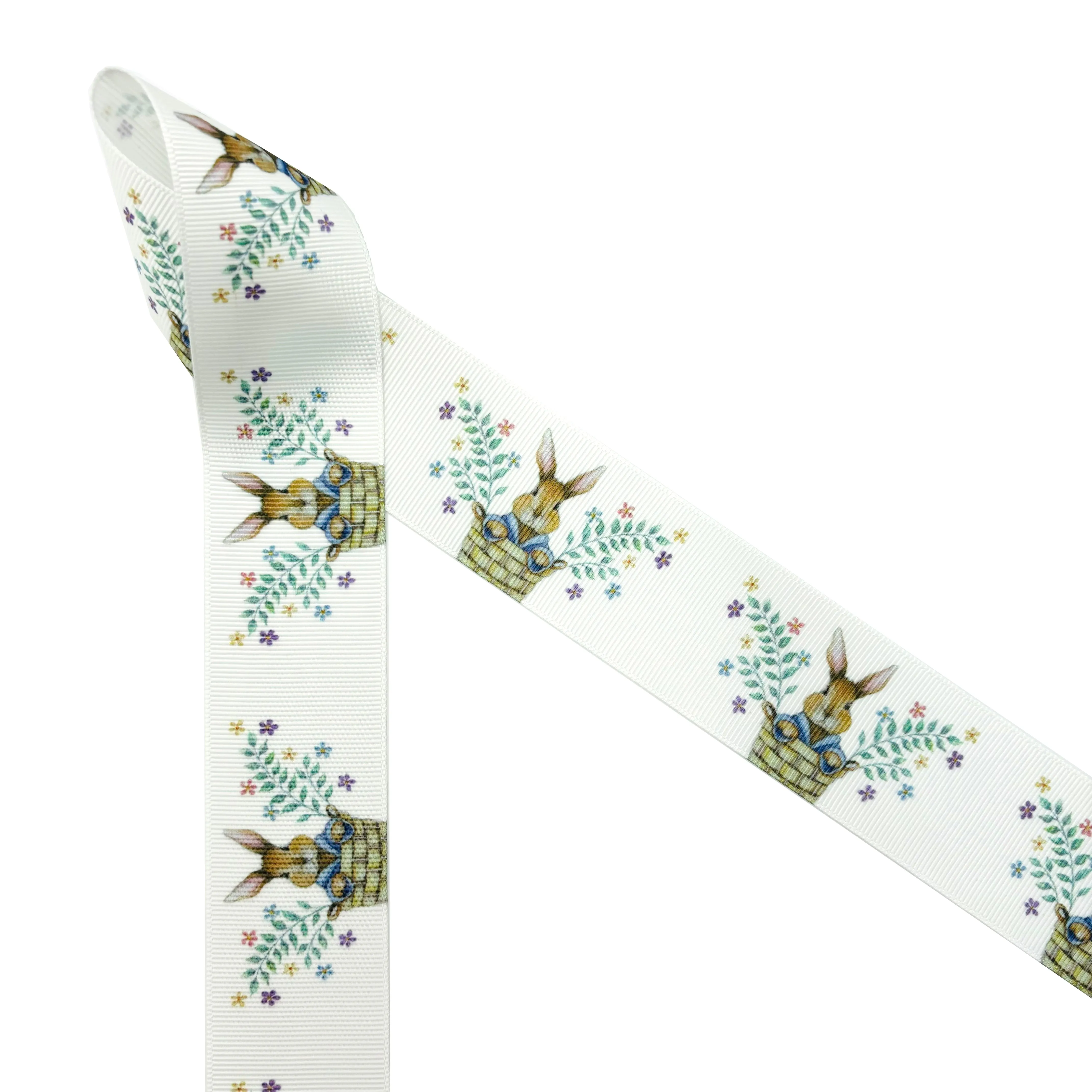 Bunny ribbon Easter bunny pops out of a basket with sprigs of Spring flowers printed on 1.5" white satin and grosgrain
